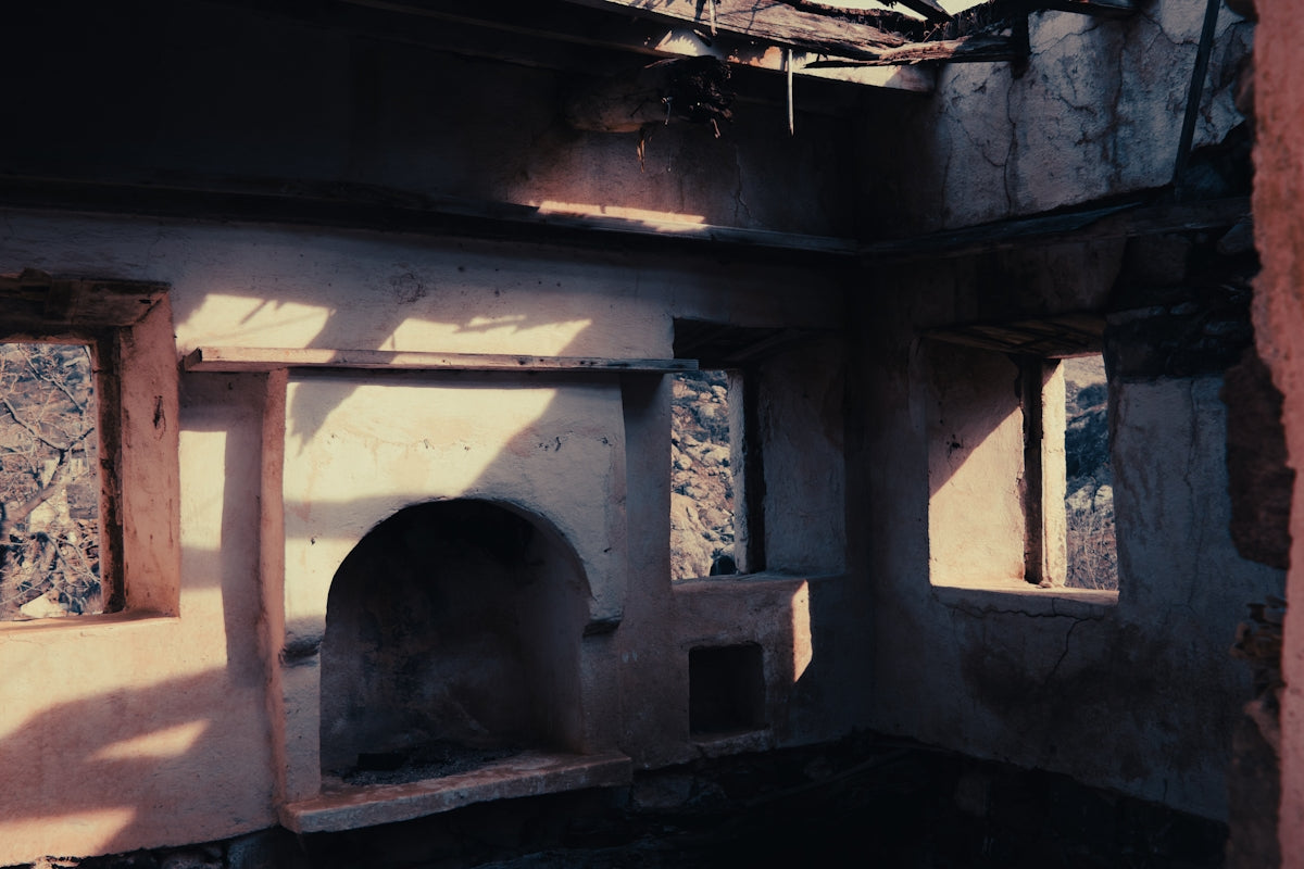 a room that has a stone fireplace in it