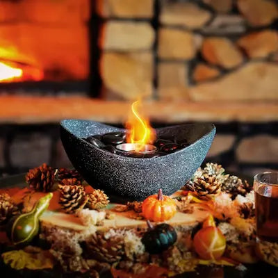 Bio ethanol tabletop fireplace on autumn table with warm flame and rustic fireplace background