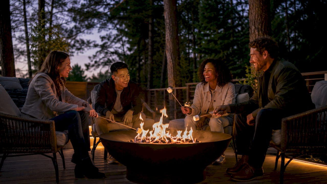 Diverse group enjoying backyard fire pit gathering